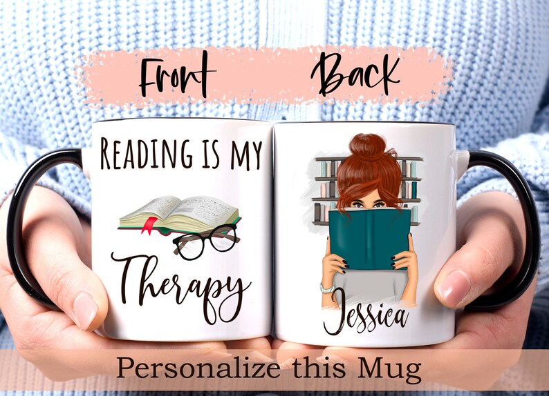 May include: White ceramic mug with a black handle. The front of the mug reads "Reading is my Therapy" with a book and glasses illustration. The back of the mug features a woman with brown hair reading a book in a library setting. The text "Jessica" is printed below the illustration.