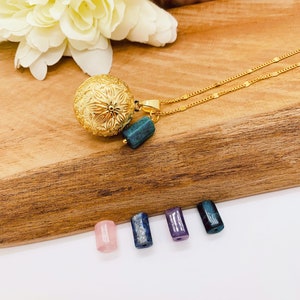 Gold pregnancy bola with flower patterns and natural stone pendant