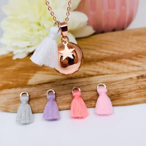 Pink gold plated and stainless steel pregnancy bola with small star charm and pompom.