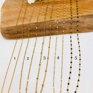 May include: Five gold chains with different styles of links and beads. The chains are numbered 1 through 5.