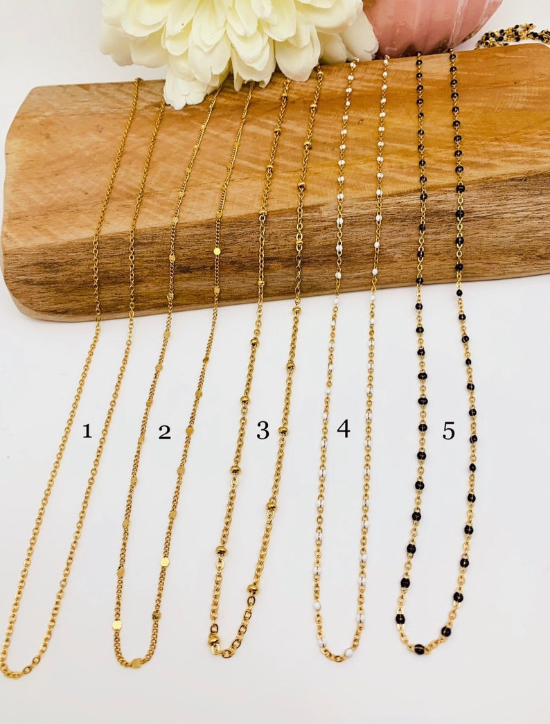 May include: Five gold chains with different styles of links and beads. The chains are numbered 1 through 5.