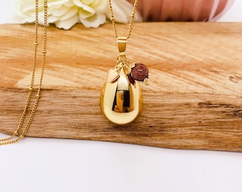 Pregnancy bola in a teardrop shape, plated in 18k gold, with a semi-precious stone charm