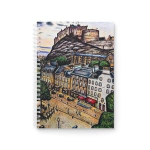 May include: A hand-drawn illustration of Edinburgh Castle, Scotland, with a view of the city below. The illustration is done in black and white with a touch of color. The castle is perched on a hilltop and the city streets are lined with buildings.
