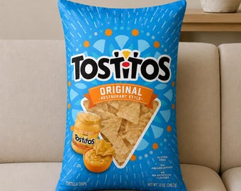 May include: A rectangular throw pillow featuring a blue Tostitos Original tortilla chips bag design. The graphic includes the Tostitos logo, an orange banner, a clear window showing chips, a jar of salsa con queso, and text stating 12 oz.