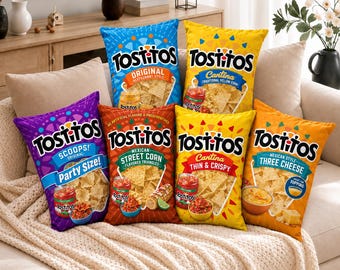 May include: Six rectangular throw pillows designed to look like Tostitos tortilla chip bags. The pillows feature various Tostitos branding, including Original, Cantina, Scoops, Mexican Street Corn, Thin & Crispy, and Three Cheese, with colorful graphics.
