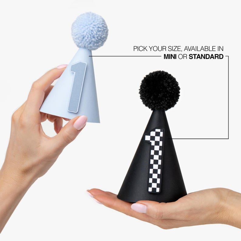 Hands Holding First Birthday party hats in Powder Blue and Black and White with Checkerboard Race Flag Theme Decoration Showing Size Options