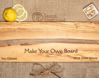 May include: A wooden cutting board with a clear epoxy river running through the center. The board is engraved with the text "Make Your Own Board" and the phrases "You Choose" and "What Goes Where".