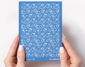 May include: A blue nail art design sheet with a white pattern of pumpkins, leaves, and coffee cups. The sheet has the text "Clay parafin" and "SC-399433" printed on it.