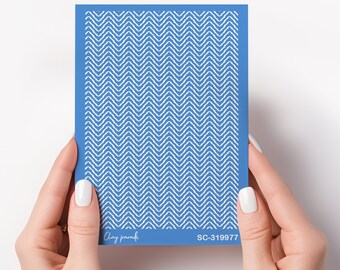 May include: A blue nail art stencil with a white chevron pattern. The stencil is labeled "Clay paradisi" and "SC-319977".