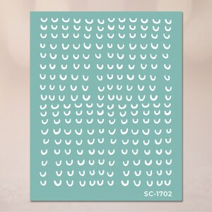 May include: A sheet of teal blue paper with a repeating pattern of white curved lines. The paper has the text "SC-1702" printed in the bottom right corner.