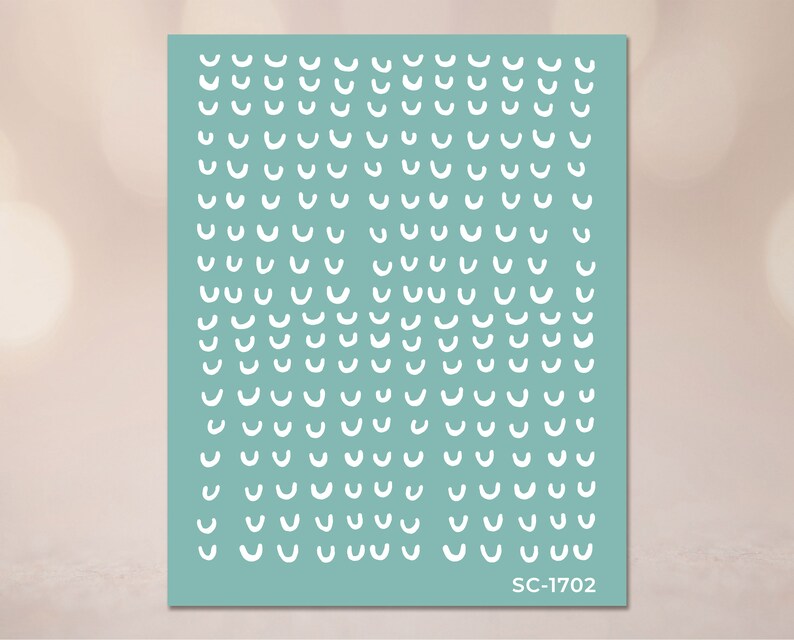 May include: A sheet of teal blue paper with a repeating pattern of white curved lines. The paper has the text "SC-1702" printed in the bottom right corner.