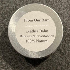 May include: A silver tin with a white label that reads "From Our Barn", "Leather Balm", "Beeswax & Neatfoot oil", and "100% Natural".
