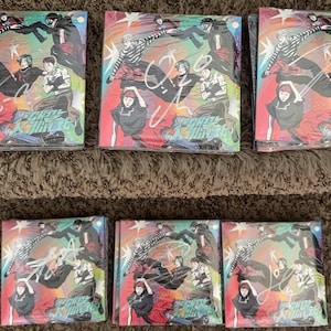 May include: Eight colorful, rectangular, printed cardboard boxes with a black and white cartoon design. The boxes feature a group of characters in various poses. The text "Fight" is printed on each box.