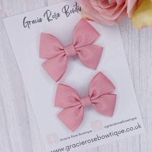 May include: Two pink satin hair bows on a white card with the text "Gracie Rose Boutique" and the website address "www.gracieroseboutique.co.uk".