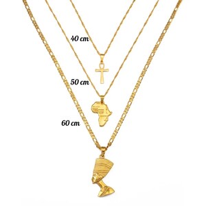 May include: Three gold-colored necklaces of varying lengths, each with a unique pendant. The shortest necklace is 40 cm long and has an Ankh pendant. The middle necklace is 50 cm long and features an Africa-shaped pendant. The longest necklace is 60 cm and has a Nefertiti pendant.