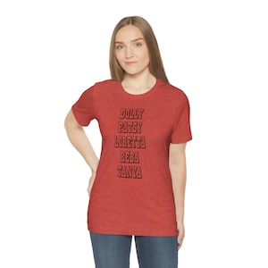May include: Red heather t-shirt with black text that reads "DOLLY PATSY LORETTA REBA TANYA"