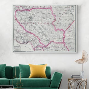 May include: A vintage map of Santa Clara County, California, with a pink border outlining the county boundaries. The map shows roads, railroads, and other features of the area. The map is printed on a white background.