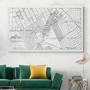 May include: A black and white vintage map print, framed in white. The map features detailed street layouts, labeled areas, and text including "Gladys City Oil" and "P. Humphrey Survey". The scale is noted as 3000 ft to the inch.