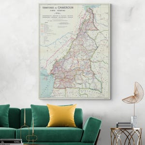 May include: A vintage map of Cameroon from 1950. The map is printed in black and white with colored lines and dots indicating roads, railways, and other features. The map is titled "Territoires du Cameroun Carte Generale 1950."