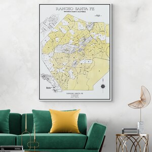 May include: A vintage map of Rancho Santa Fe, San Diego County, California. The map is printed in black and white with yellow highlights. The map shows the different land divisions of the area.