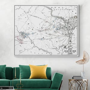 May include: A framed vintage map titled "Map Seat of War July 18th & 21st 1861" in monochrome. The map displays detailed lines and text, highlighting geographical features. The frame is black.