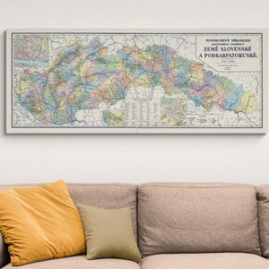 May include: A vintage map of Slovakia and Subcarpathian Rus', printed on paper with a cream background. The map is divided into regions with different colors and includes a key with names of the regions. The title of the map is "PODROBNÝ PŘEHLED POLITICKÉHO ROZDĚLENÍ ZEMĚ SLOVENSKÉ A PODKARPATORUSKÉ."