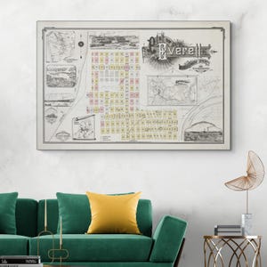 May include: A framed vintage map of Everett, Washington, showing detailed street layouts, illustrations, and the city's name in an ornate font. The map includes various cartographic elements and is displayed on a white wall above a green sofa.