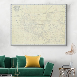 May include: Framed vintage map of Sunnyvale, Mountain View, Los Altos, and Los Altos Hills, California. The map features a detailed layout of roads, buildings, and geographical features, with text in the upper left corner. The map is framed in a white border.