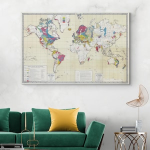 May include: A framed world map with detailed geological and geographical information. The map features a vintage aesthetic with a cream-colored background and colorful regions. The text "THE WORLD" and "LA TERRE" are visible. The map is displayed above a green sofa.
