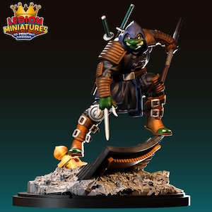 May include: A detailed 3D-printed figurine of a green-skinned, ninja-like character in a dynamic pose. The figure wears a dark blue and brown outfit with a hood, holding a sword and staff. The base features a detailed, textured design, and the logo "LEGION MINIATURES 3D PRINTING DESIGNS" is visible.