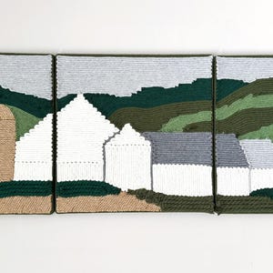 May include: A three-panel artwork depicting a rural landscape. The piece features a farm scene with a silo, houses, and rolling hills, all rendered in textured yarn. The color palette includes shades of green, white, gray, and tan.