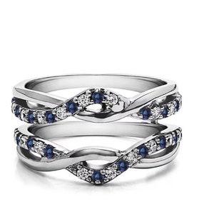 May include: A silver ring enhancer with a twisted design, featuring a row of small blue sapphires and clear diamonds.
