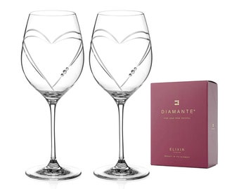 May include: Two clear glass wine glasses with a heart design and crystal accents. The glasses are in a red box with the text "Diamante Fine Lead Free Crystal Elixir Beauty in its Element".