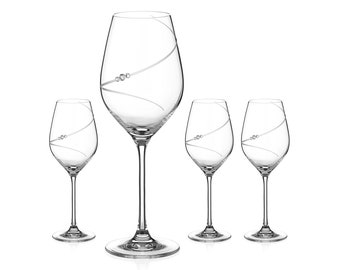 May include: Set of four clear glass wine glasses with a swirl design and a single crystal accent. The glasses are arranged in a row on a white background.