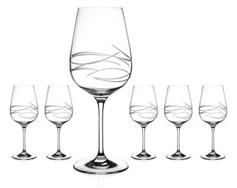 May include: Set of six clear glass wine glasses with a swirl design. The glasses have a tall, slender stem and a wide bowl.
