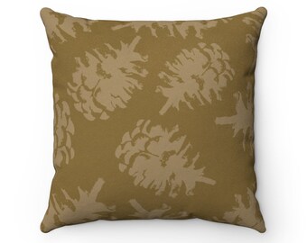 May include: A brown throw pillow with a repeating pattern of beige pine cones.