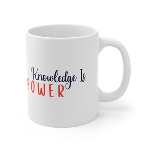 May include: White ceramic mug with the text "Knowledge is POWER" in navy blue and red lettering.