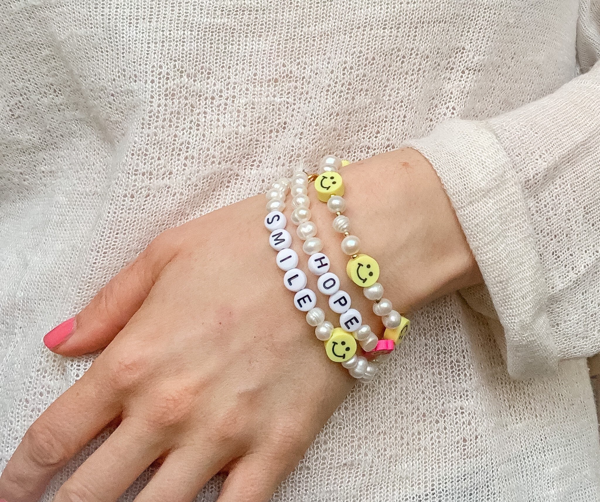 Smiley pearl bracelet deals