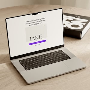 May include: A laptop computer open to a website with the text "A template created by Leigh Studios was shared with you. Start designing now." and a purple button that says "Get Started". The website also features the text "IANE." in a white box.