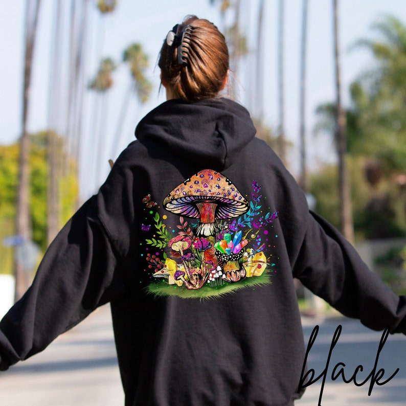 May include: Black hooded sweatshirt with a colorful mushroom and floral design on the back.
