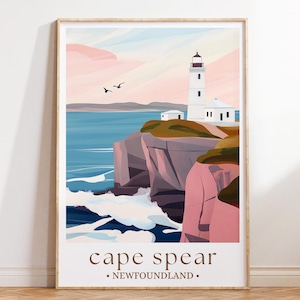 May include: Framed art print depicting a coastal landscape with a white lighthouse on a cliff. The artwork uses a minimalist style with pastel colours, including pink, blue, and green. The text "cape spear .NEWFOUNDLAND." is at the bottom.