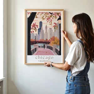 a woman standing in front of a picture hanging on a wall
