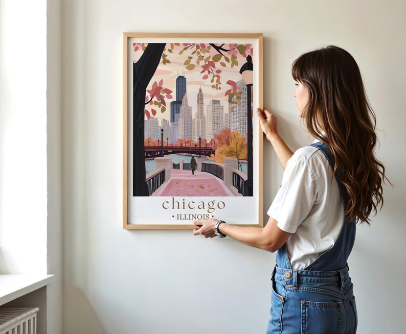 a woman standing in front of a picture hanging on a wall