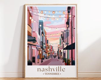 May include: A framed art print of a street scene in Nashville, Tennessee. The illustration depicts a vibrant street lined with buildings in shades of pink and peach, with string lights overhead. The word "nashville" is printed at the bottom.