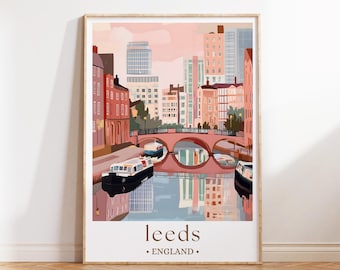 May include: A framed art print featuring a stylized illustration of Leeds, England. The artwork depicts a canal scene with boats, bridges, and buildings in shades of pink, red, and blue. The word "leeds" and "England" are printed at the bottom.