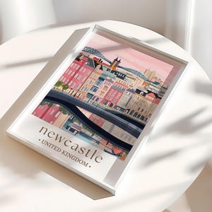 A framed poster of Newcastle, United Kingdom, with a colorful illustration of the city's buildings and landmarks.