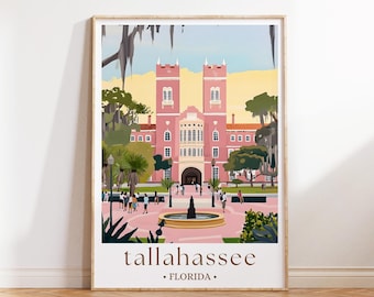 May include: A framed art print featuring a pink building with two towers, a central archway, and a fountain in front. The print includes the text "tallahassee FLORIDA" in a brown font, and depicts people walking around the building.
