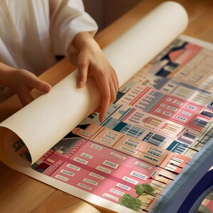 A person's hands are holding a roll of paper over a colorful, illustrated cityscape.