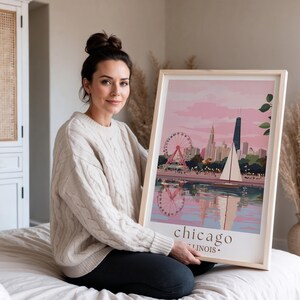 a woman sitting on a bed holding a picture