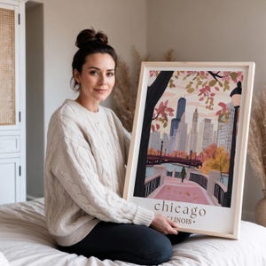 a woman sitting on a bed holding a picture